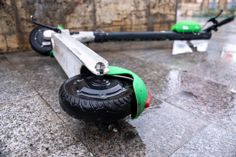 lying electric scooter sharing wet ground cloudy weather bucharest romania